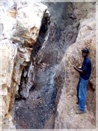 Rockson Coffie PGeo mapping structure where locals heat the quartz veins with fire and splash with water&nbsp;to break the rock for extracting gold.